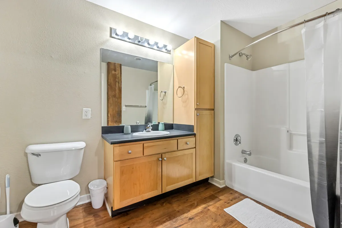 A modern bathroom with a stylish vanity and sink, a full-length mirror, and a thoughtfully designed shower area. The space is bright, functional, and exudes a sense of relaxation, making it ideal for personal grooming and unwinding after a busy day.